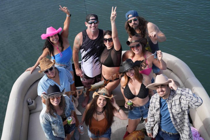 a group of people on a boat posing for the camera